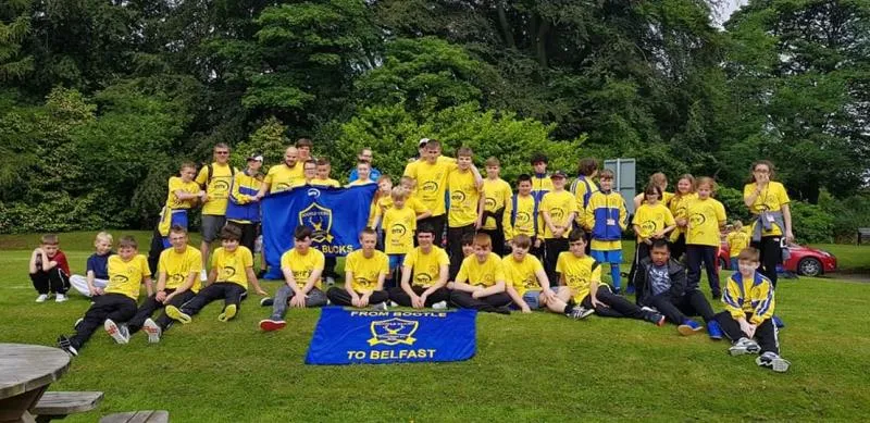 The club group holding a flag together