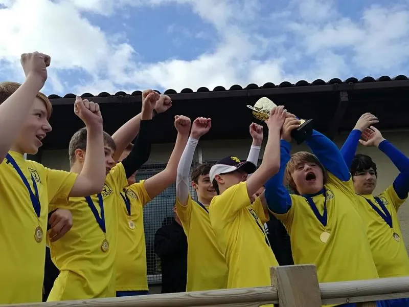 Bootle Bucks squad cheering together in their yellow kit