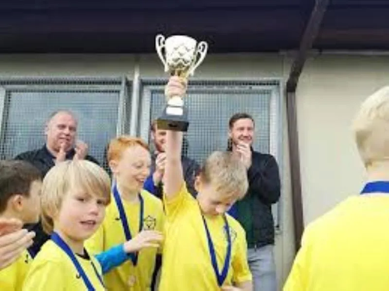 Players gathered around a trophy