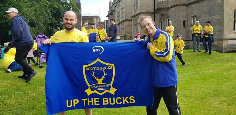 Bootle Bucks supporters holding the Up the Bucks club flag